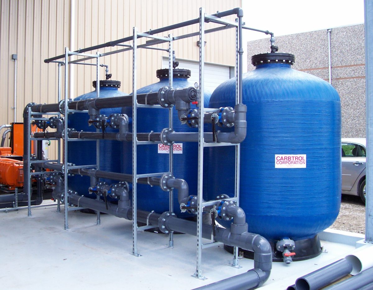 Water treatment specialist testing filtered water quality at whole-home system