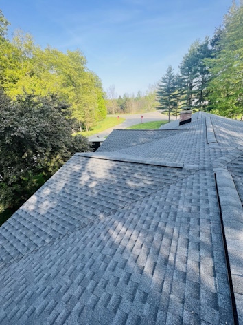 Skilled technician meticulously installing high-quality roofing on a Vicksburg home